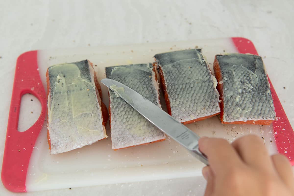 Spreading Ghee Onto Salmon Skin With Knife