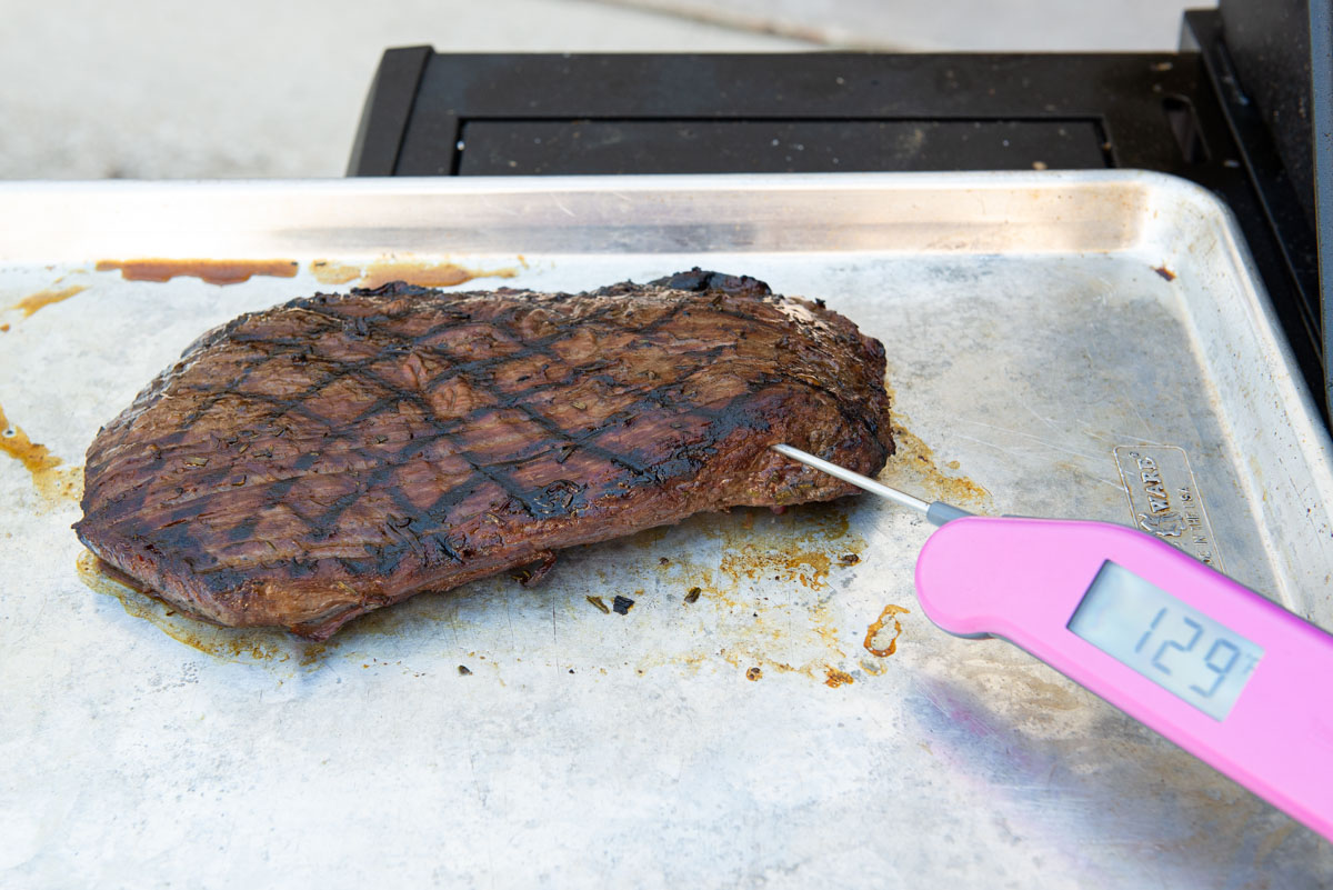 An Instant Read Thermometer showing an internal temperature of 129F for the meat