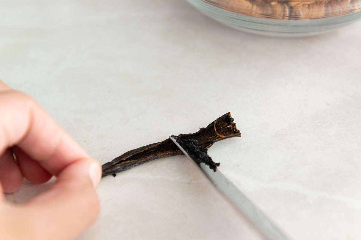 Scraping a vanilla bean with a knife
