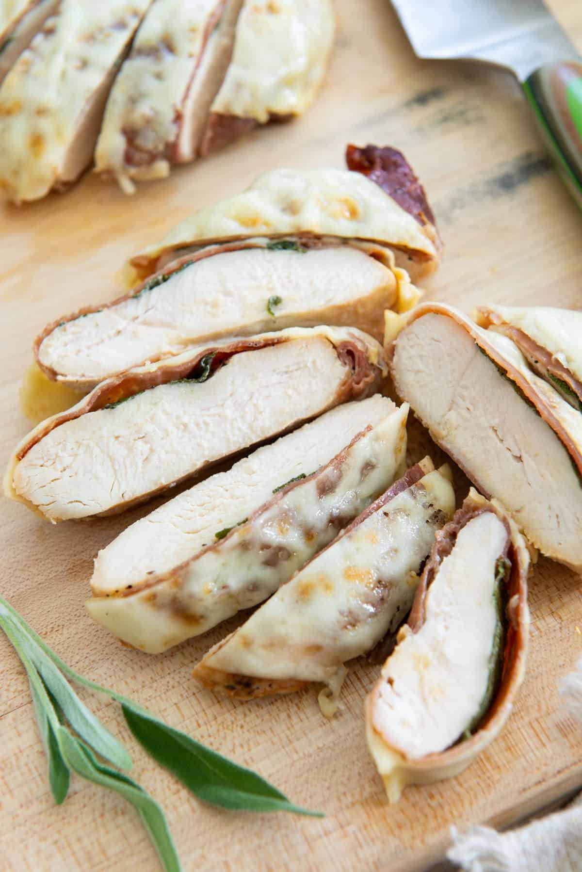 Chicken Saltimbocca Sliced On Wooden Board with Provolone Cheese