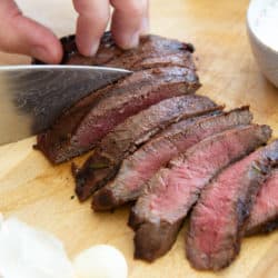 Sliced Marinated Flat Iron Steak on Wooden Board