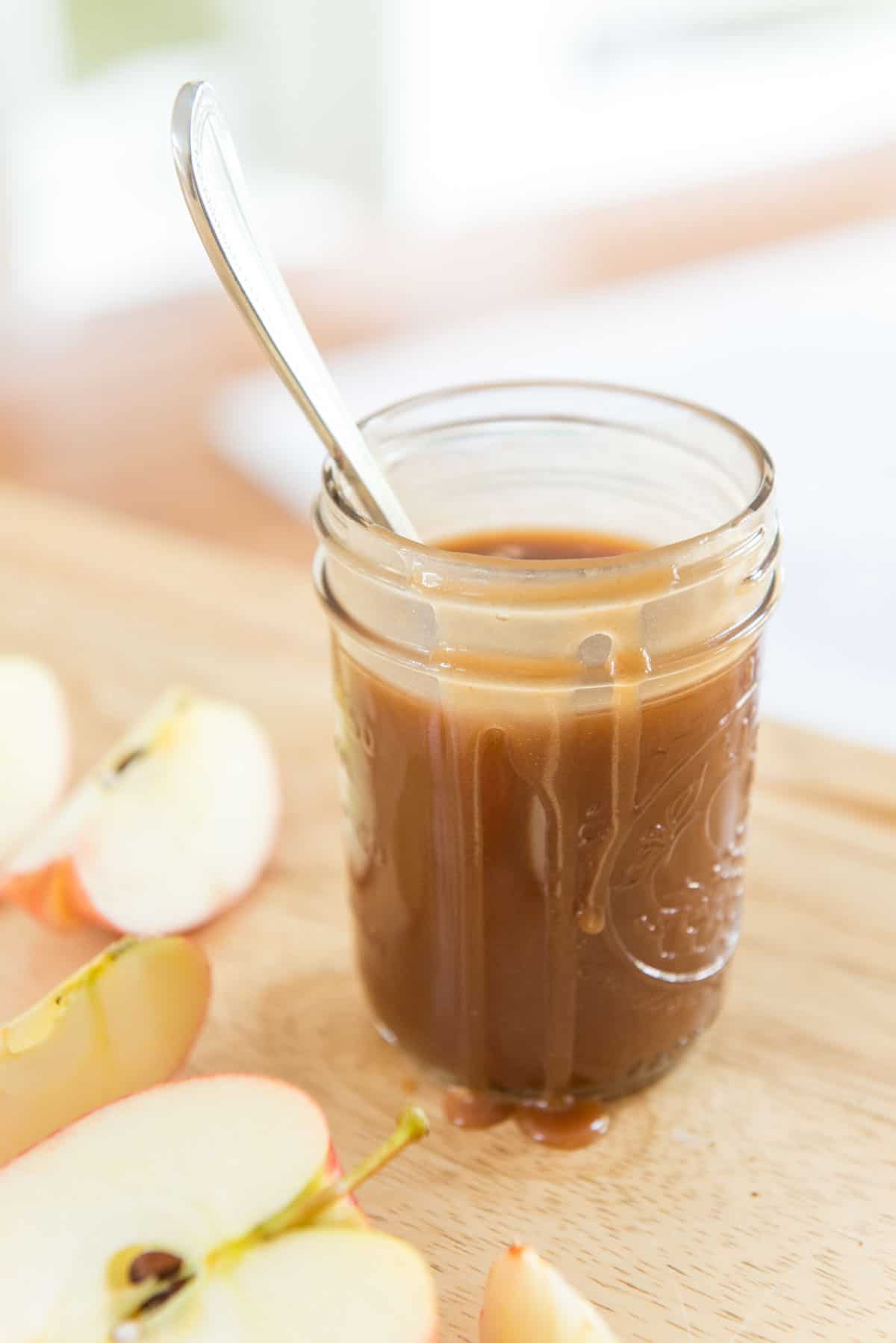 Caramel Sauce In a Glass Jar with Caramel Dripping Down the Side