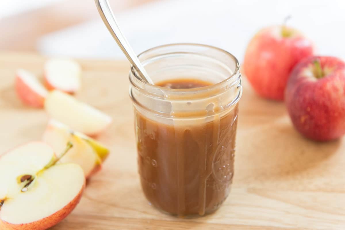 Caramel In a Jar with Spoon and Apple Slices on Side