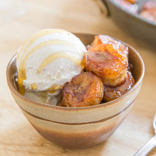 Pan Fried Bananas in Bowl with Vanilla Ice Cream and Honey Drizzle