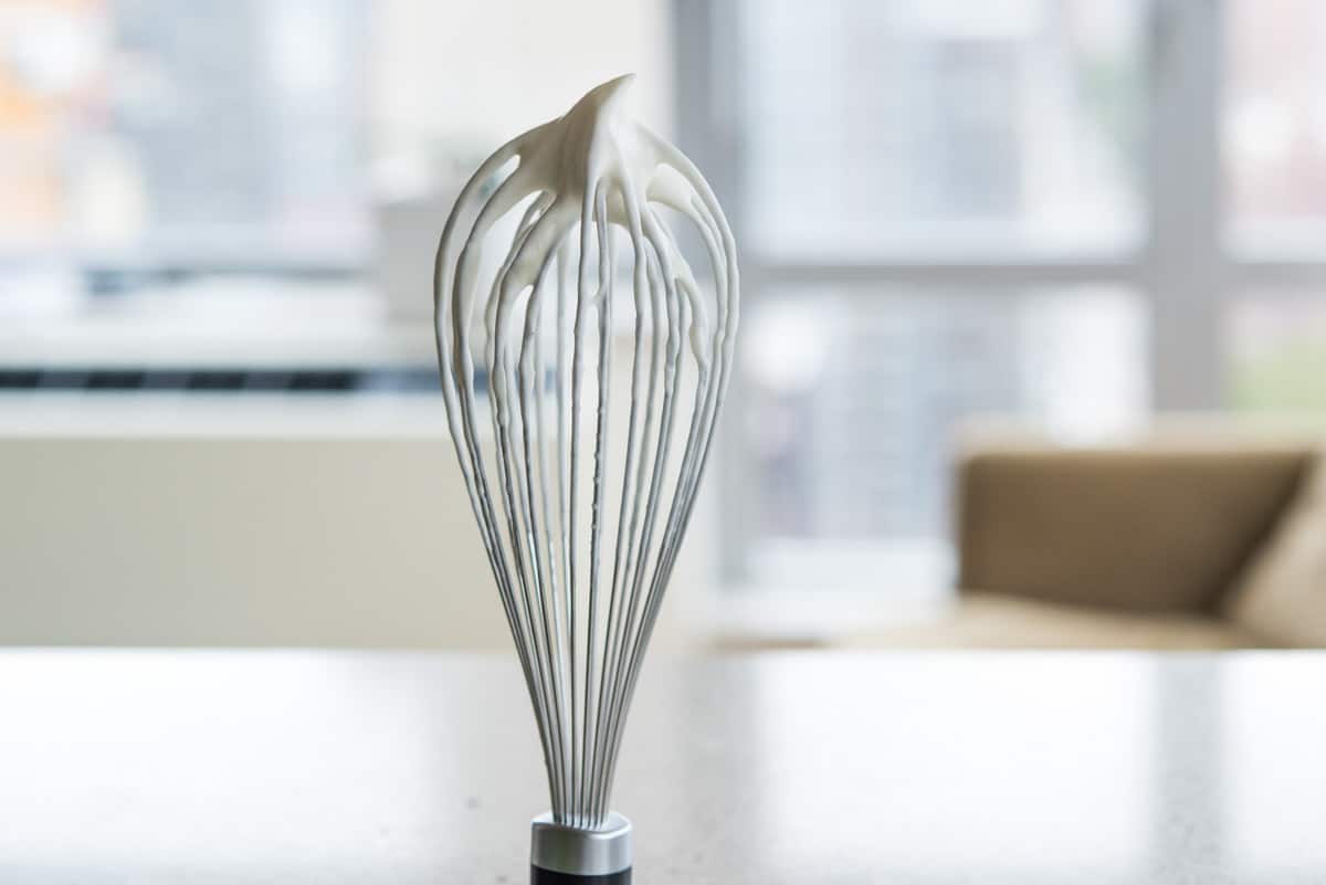 A whisk upside down showing soft peaks