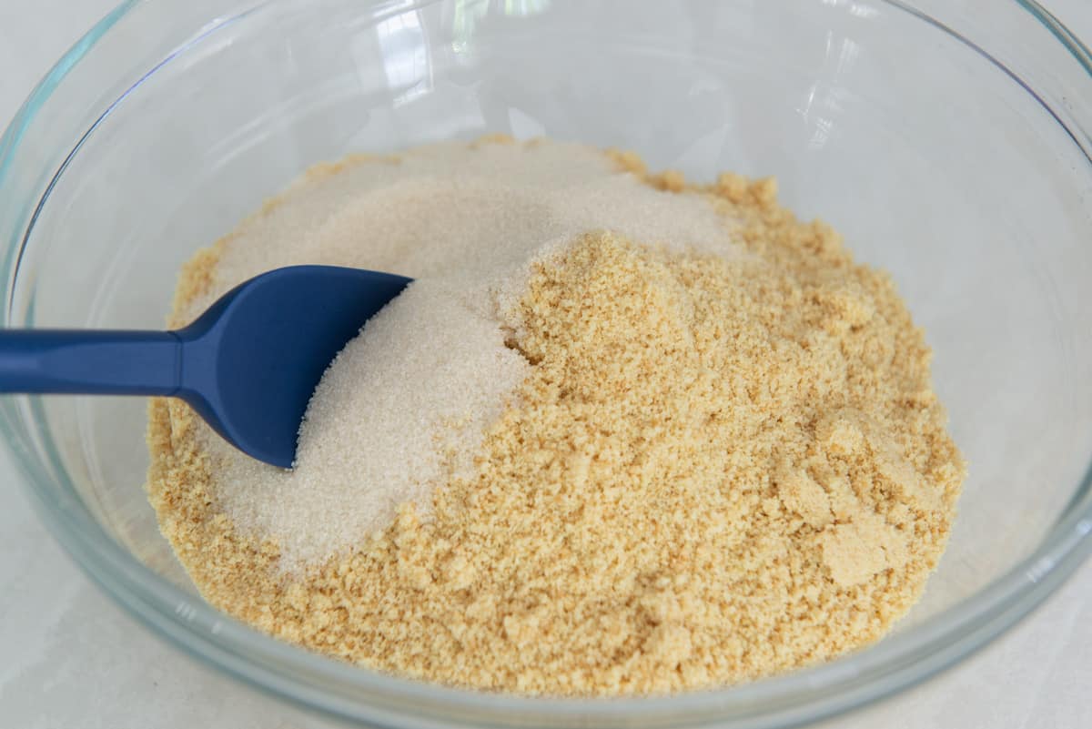Vanilla wafer cookie crumbs in a mixing bowl with sugar