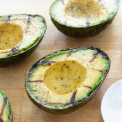 Grilled Avocado On a wooden board with salt