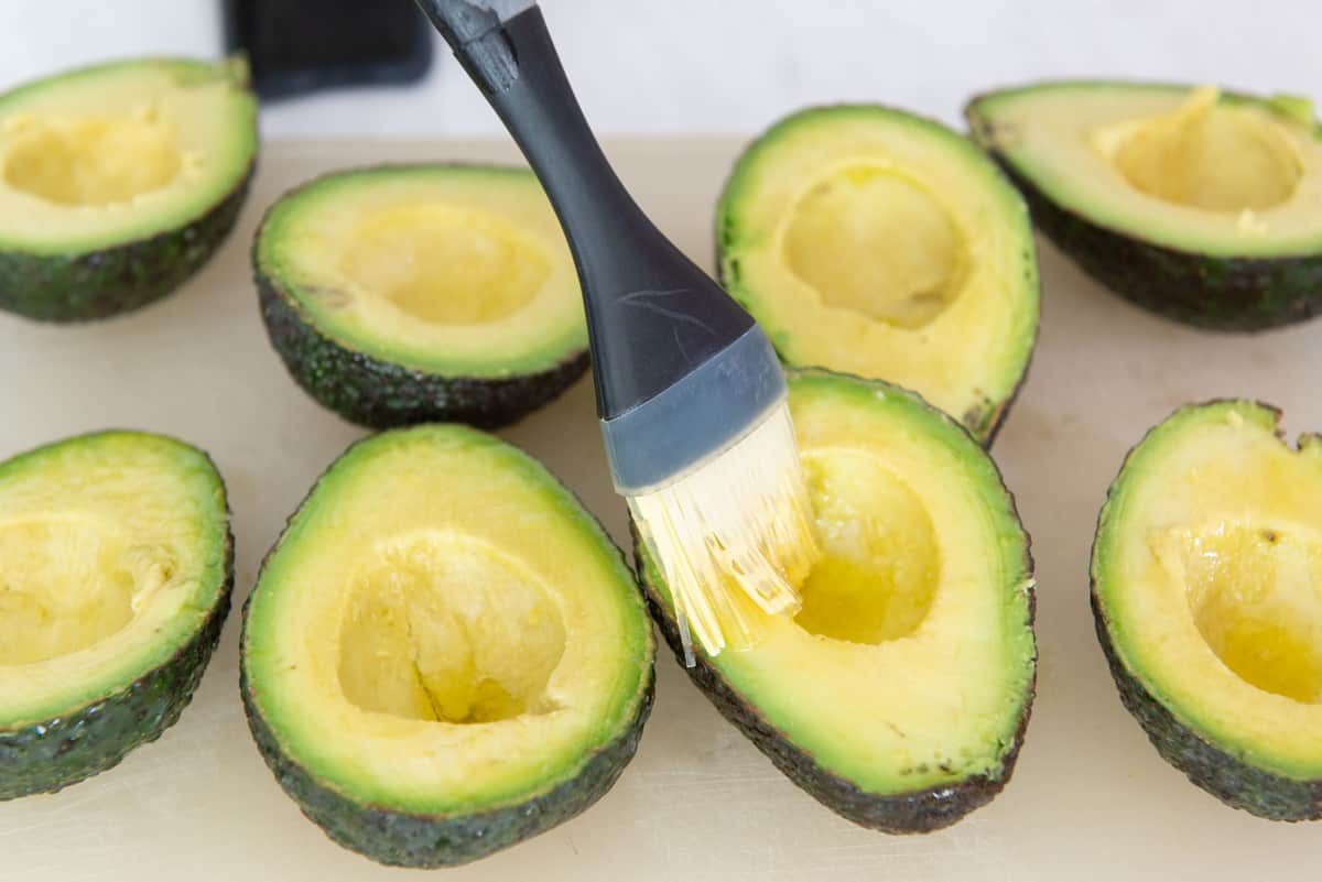 Brushing Cut Avocado Halves with Olive Oil