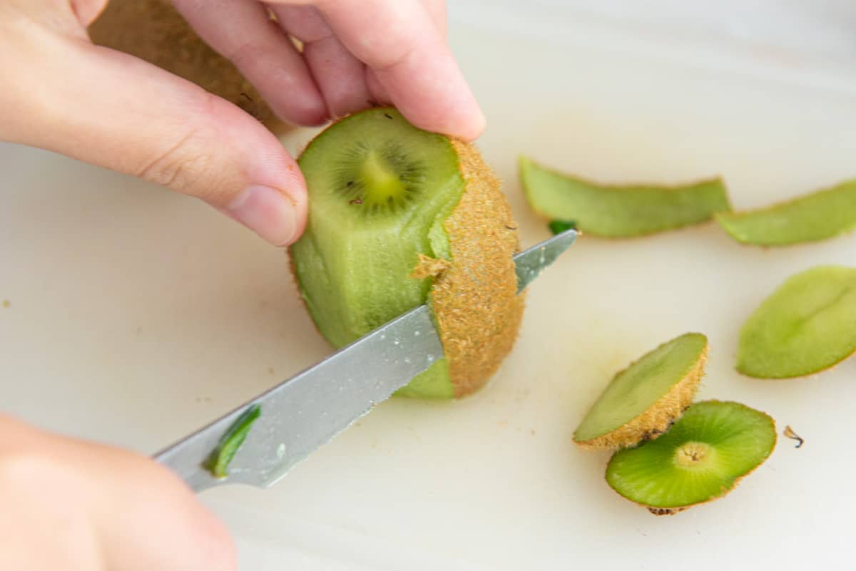 Cutting the Skin Off a Kiwi Fruit with Knife
