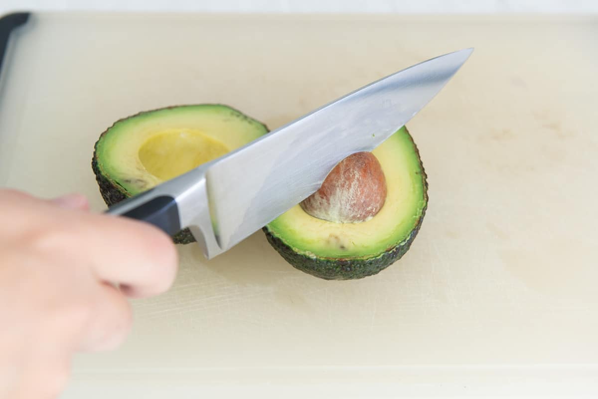 Using a Chef's Knife to Remove The Pit Of An Avocado