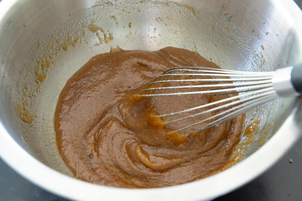 Whisking together the wet ingredients in a mixing bowl with whisk