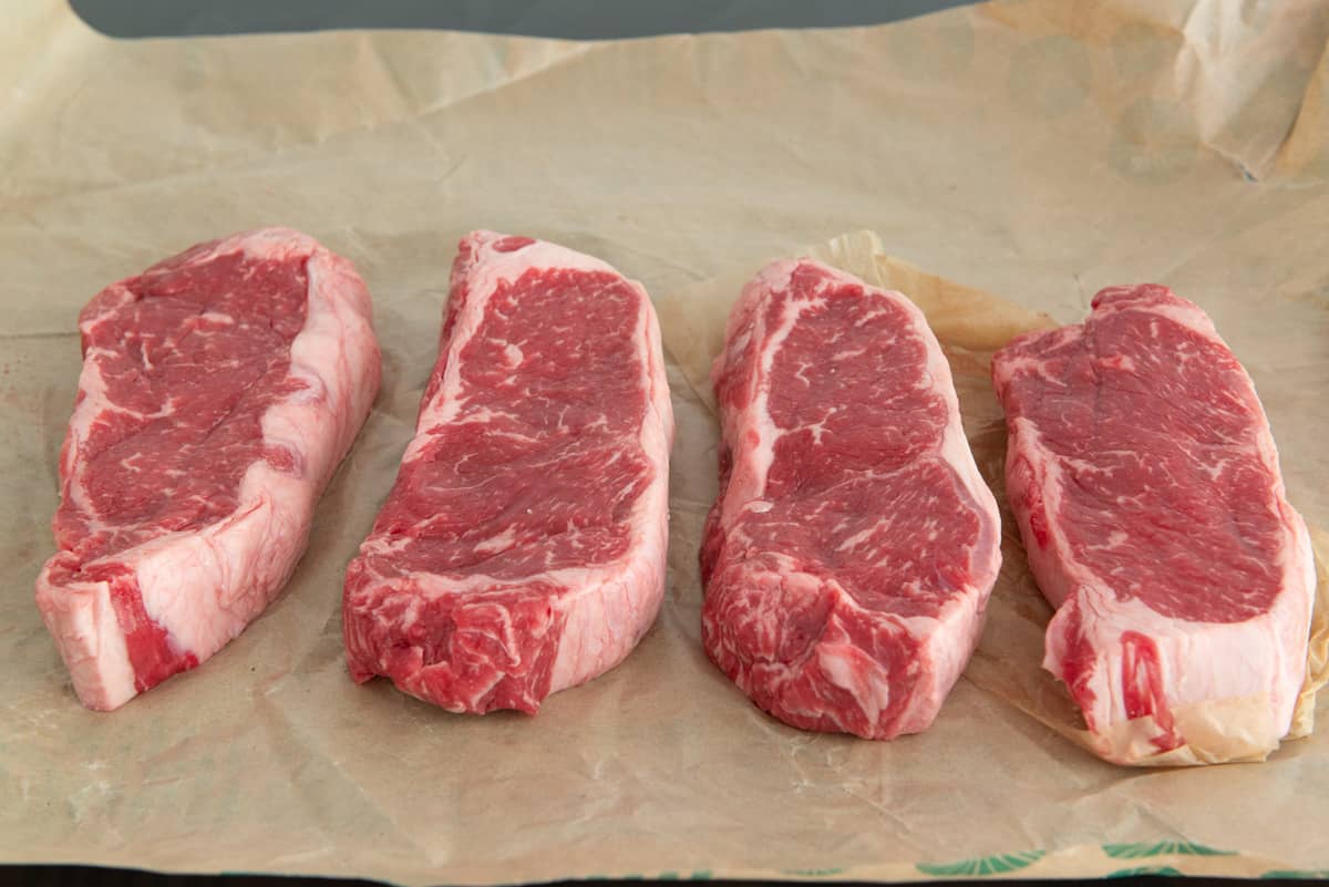 4 NY Strip Steaks On Butcher Paper