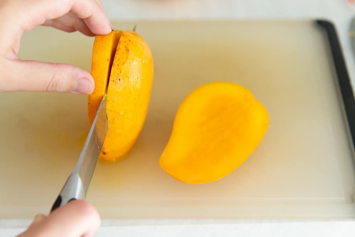 Slicing a Mango with Chef's Knife On Board