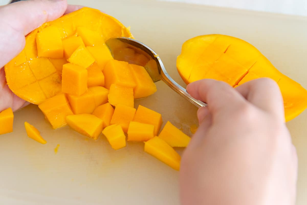 Scooping Mango Cubes Out With Spoon