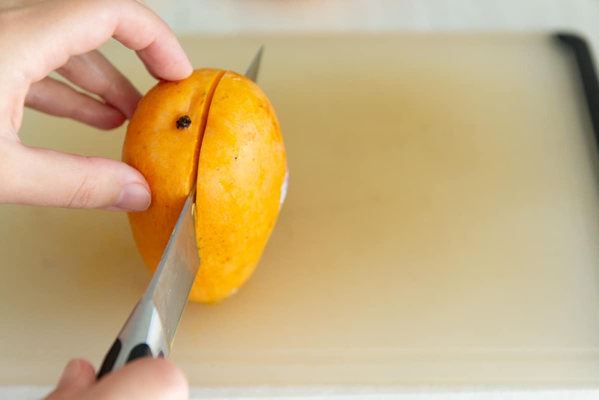 Cutting Around the Pit Of A Mango With Knife