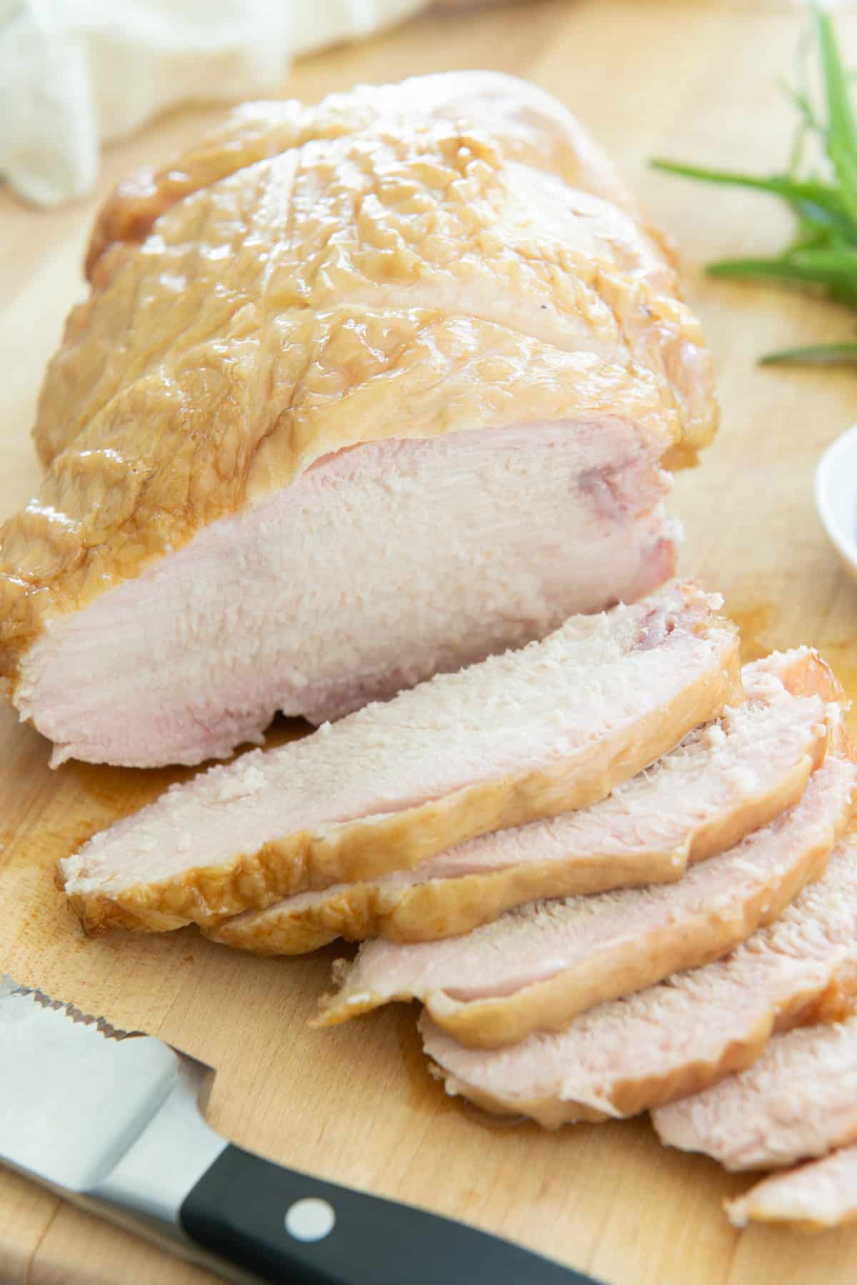 Slices of Smoked Turkey Breast on Wooden Board