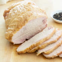Slices of Smoked Turkey Breast On Wooden Cutting Board