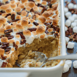 sweet potatoe casserole topped with marshmallows and pecans