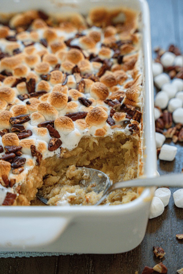 Sweet potato casserole topped with golden brown marshmallows and pecans