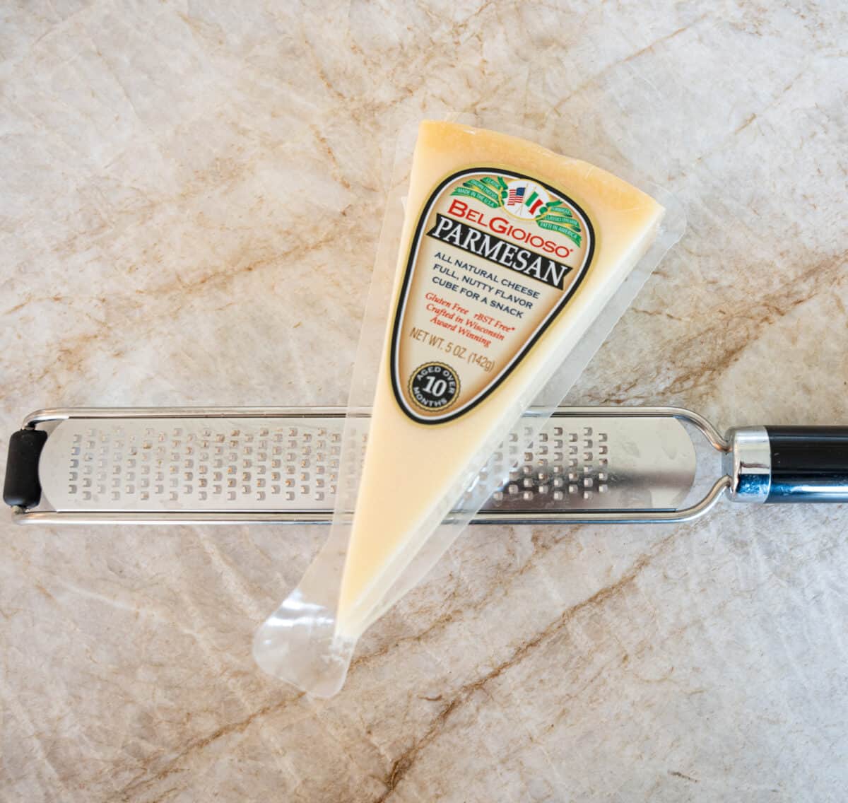 block of parmesan cheese over microplane