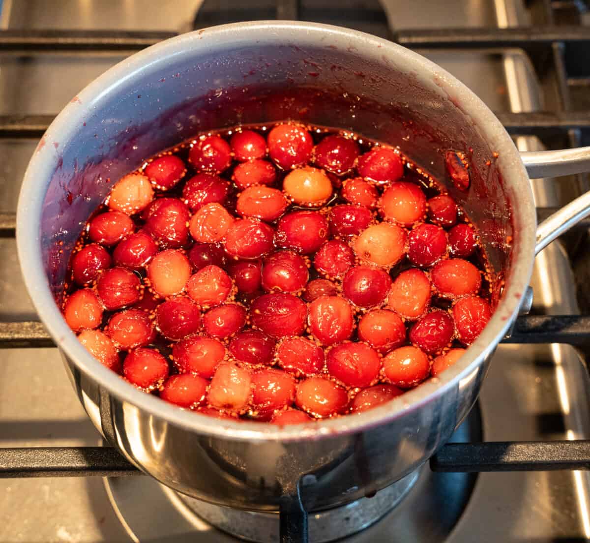 Simmering homemade cranberry sauce in small pot
