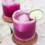 2 prickly pear margaritas with lime garnish