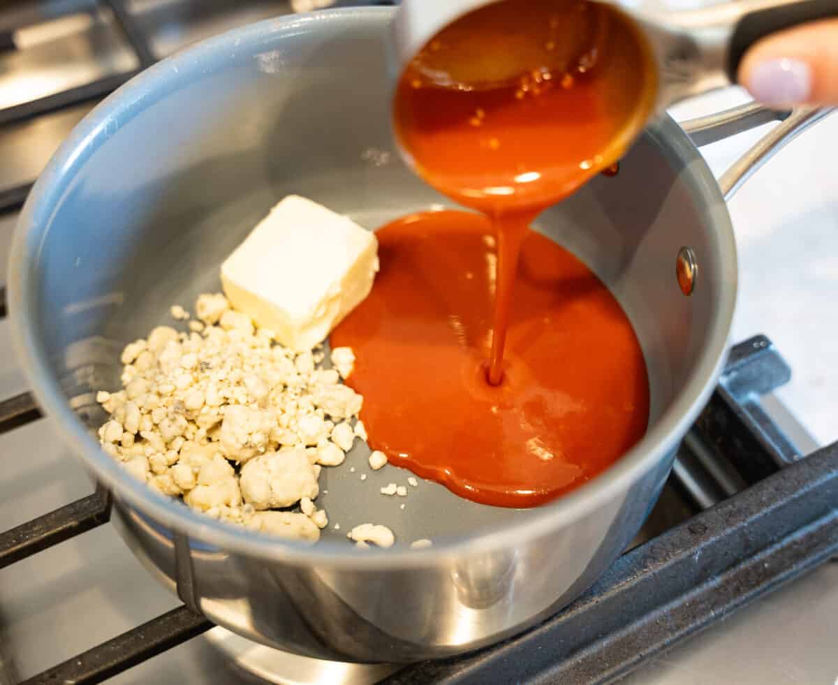 blue cheese crumbles, butter, hot sauce melting in pot