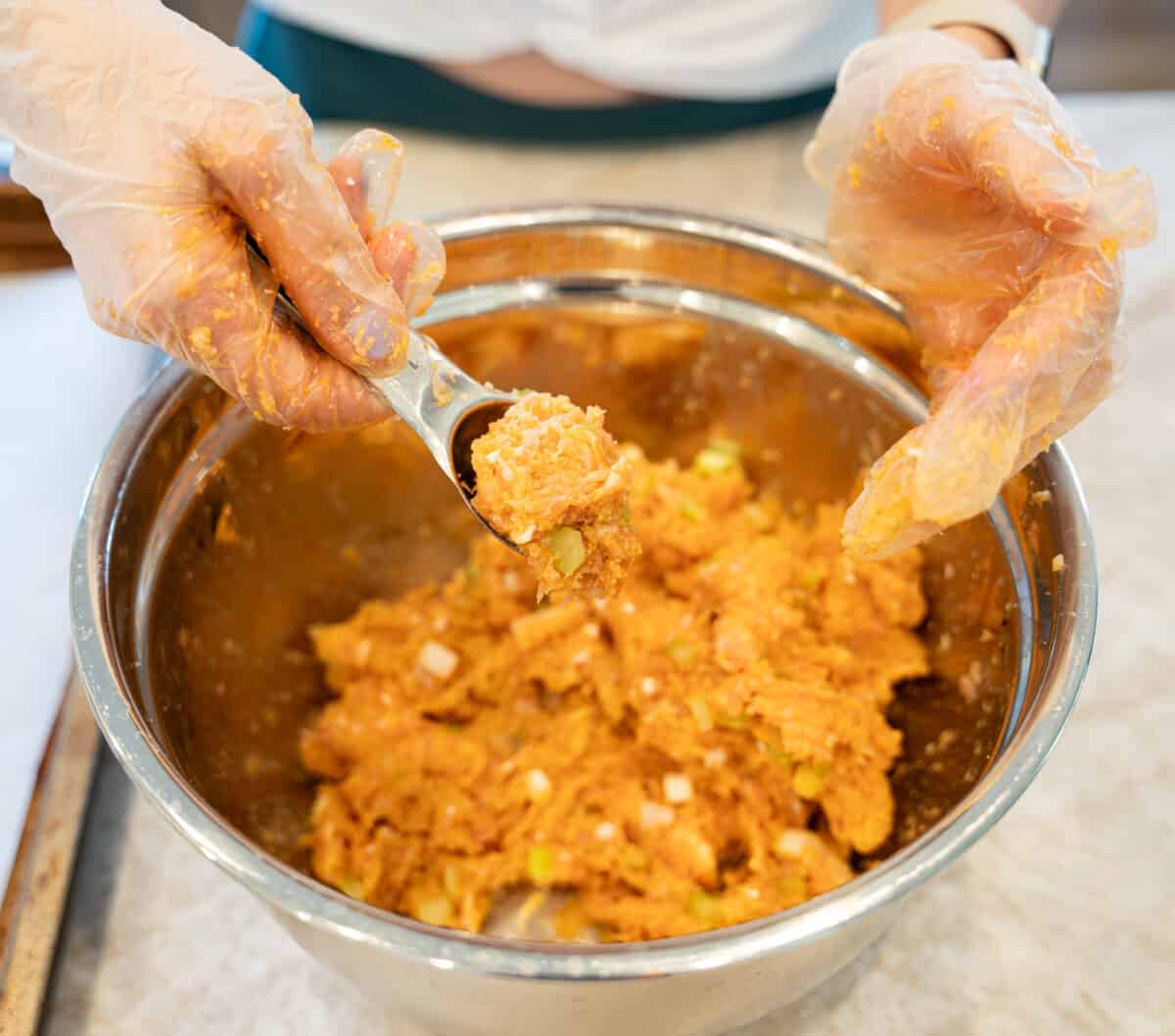 Forming buffalo chicken meatballs into balls