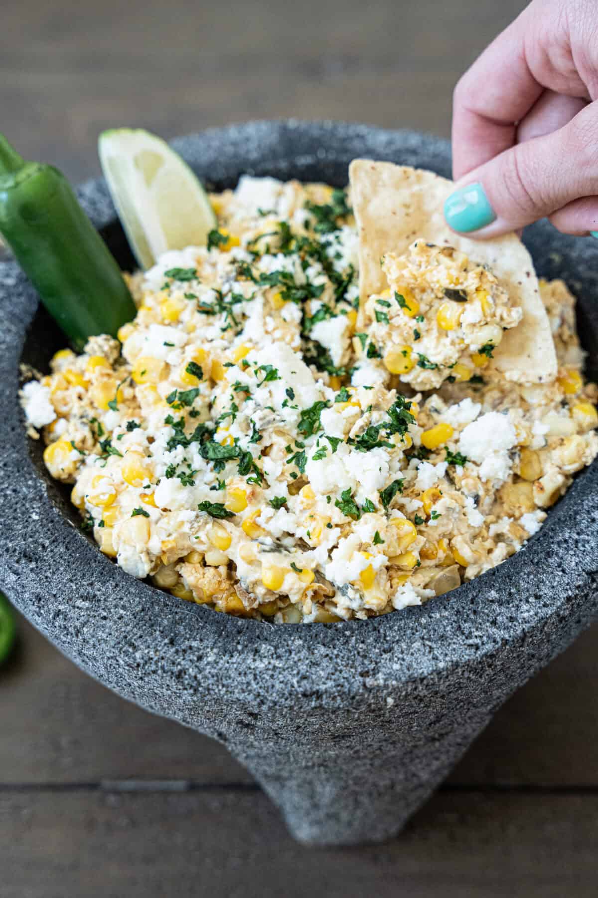 Street corn dip with chip being dipped