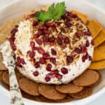 Christmas cheeseball on plate surrounded by crackers