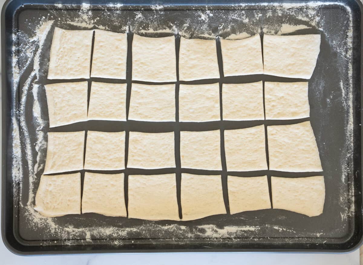 Pizza dough lightly floured on baking sheet