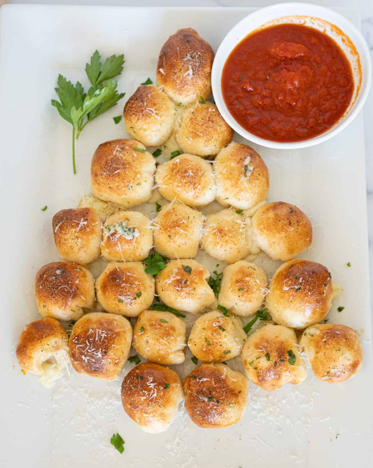 bread formed into christmas tree shape with marinara sauce