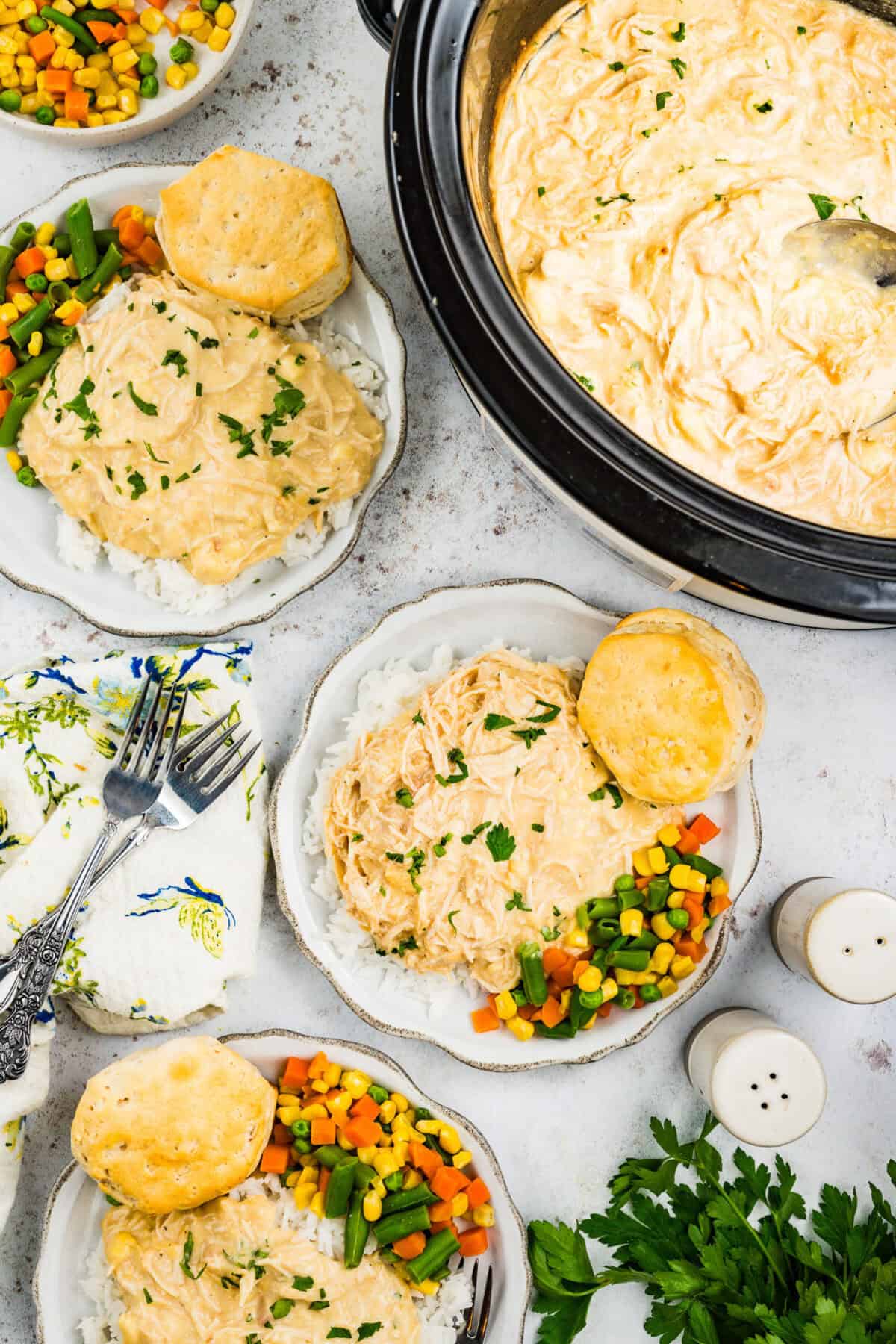 slow cooker chicken and gravy plated with rice and veggies