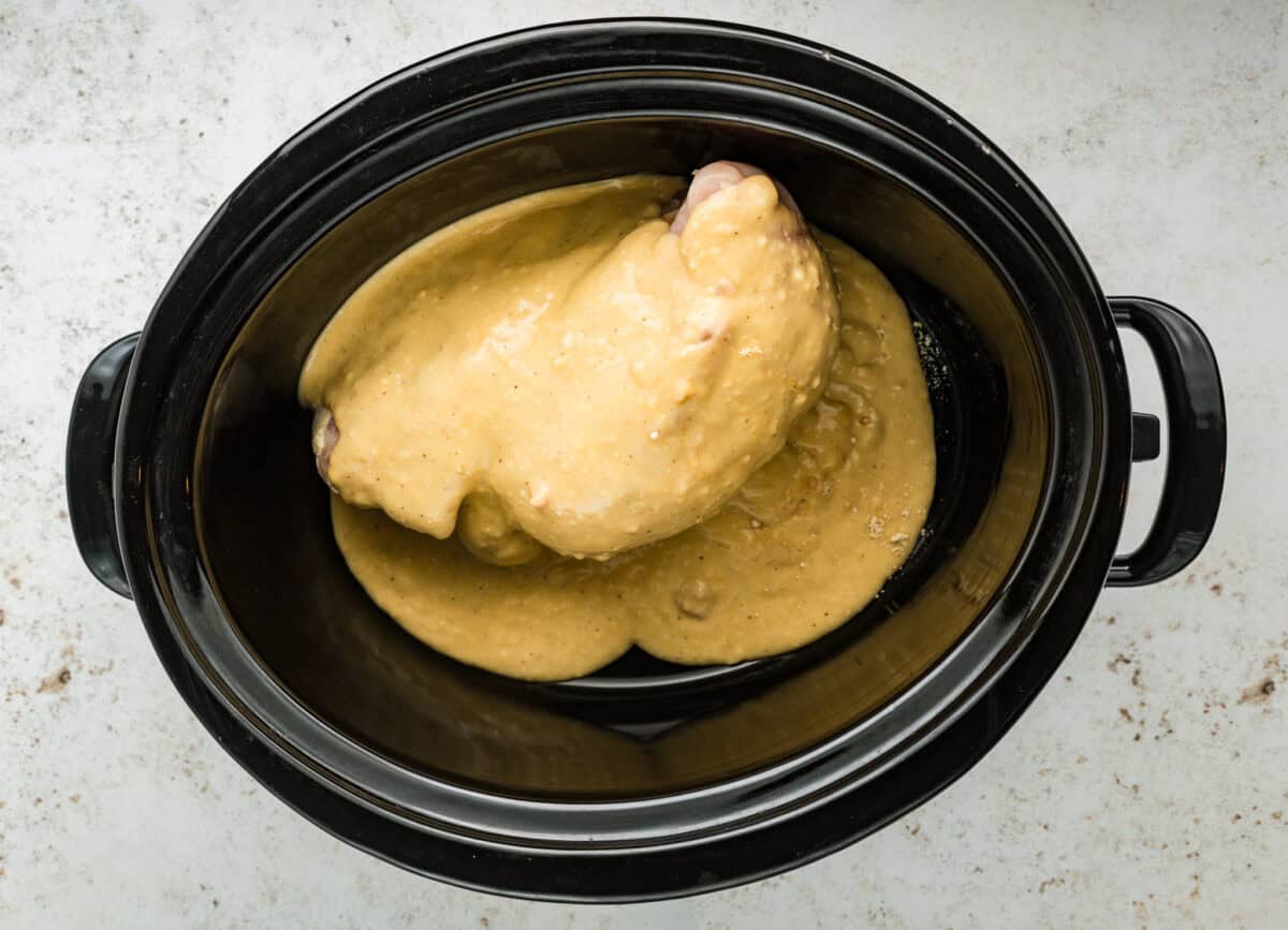 gravy poured over chicken in crock pot