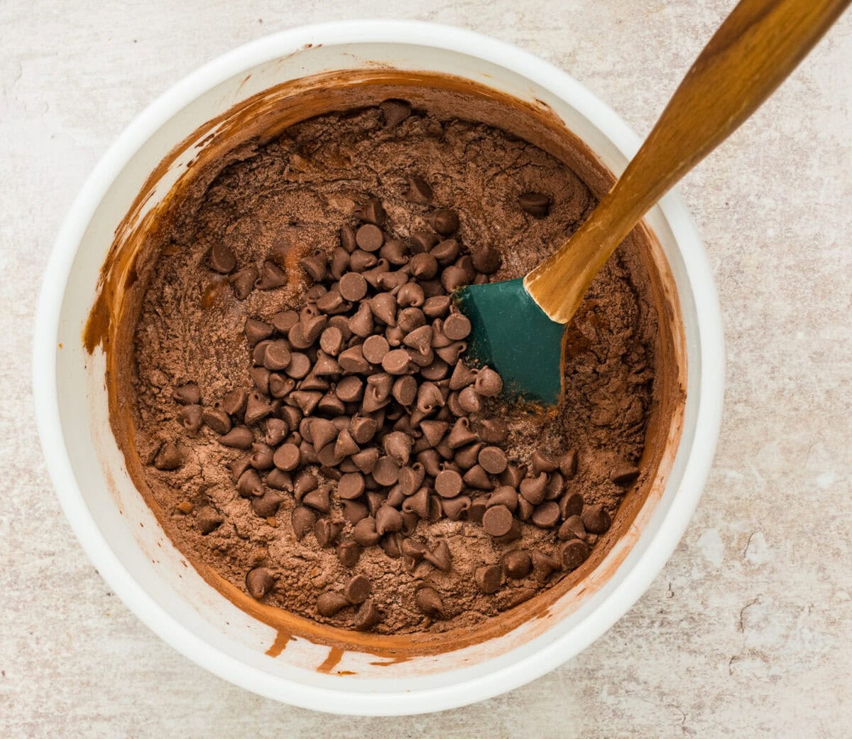mixing chocolate chips into brownie mix